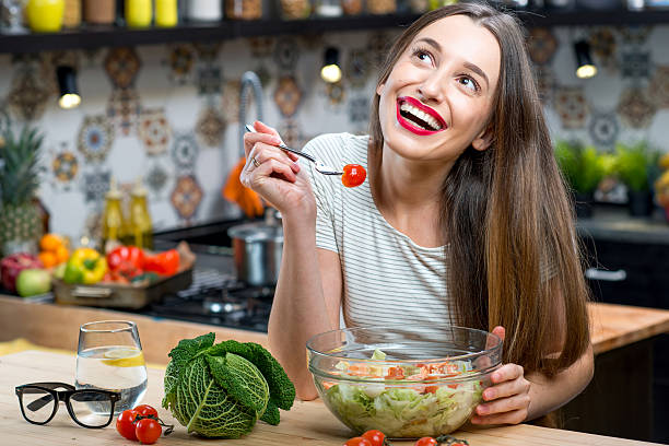 istock Woman with salad in the kitchen 627445490