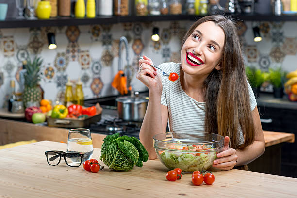 istock Woman with salad in the kitchen 627445560