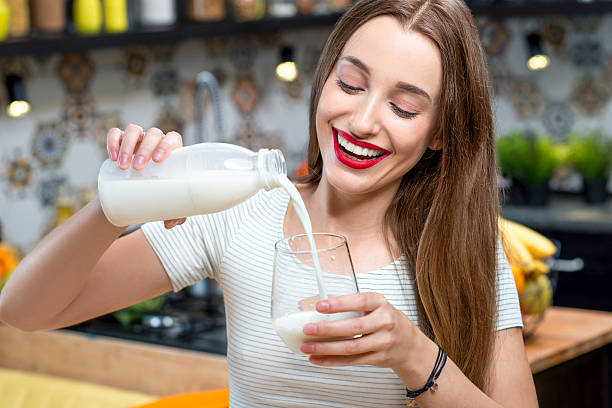 istock Woman with milk in the kitchen 627447698