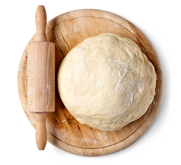 istock fresh raw dough on wooden board 627447952