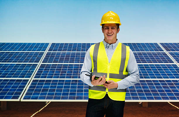 istock Smiling solar worker standing outdoors 627448364