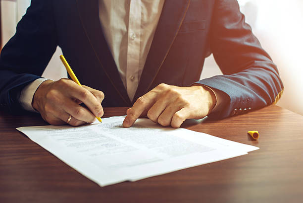 istock Man businessman signs documents with a pen 627454310