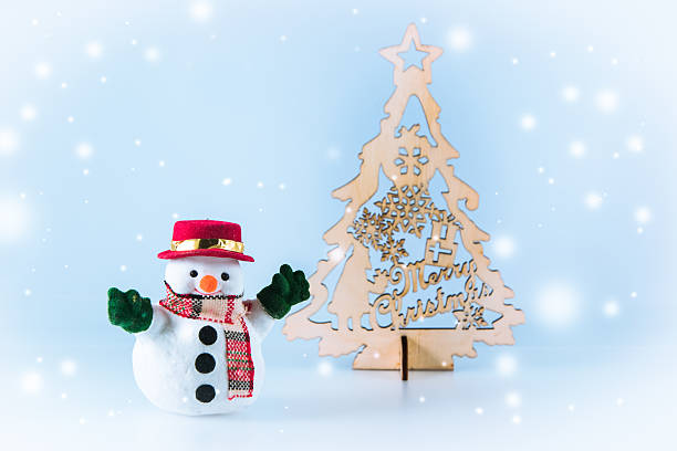 istock Snowman stand near christmas tree 627455402