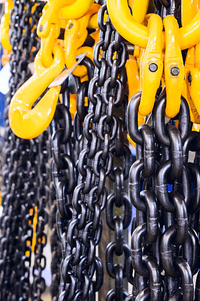 istock Black steel chain and yellow cargo hooks. 627456268