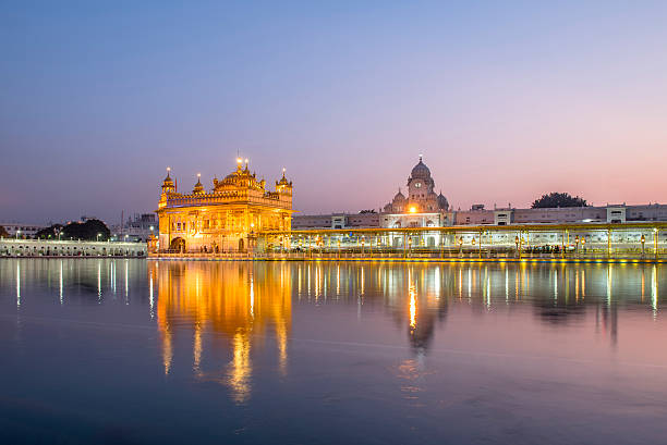 istock Golden Temple against pinky sky in Amritsar, India 627460208
