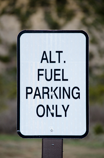 A parking lot sign designating spaces for cars that run on alternative fuels is a new addition to some national parks.