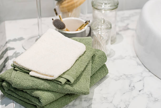 folded cotton towel under white marble bathroom marble counter