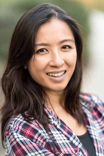 istock Smiling asian woman looking at the camera 627462438