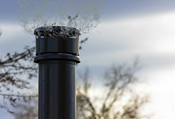 stovepipe chimney against a cloudy sky. - pipe range imagens e fotografias de stock