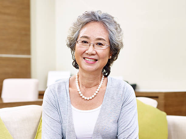 portrait of senior asian woman portrait of a senior asian woman, looking at camera smiling chinese woman stock pictures, royalty-free photos & images