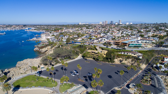 A view of Corona Del Mar in Newport Beach and the Newport Coastline, Southern California. This is right next to the famous Wedge surf spot. The Wedge is a jetty that protects the Newport Harbor, as waves approach, the jetty funnels waves into double, even triple their size to create a unique and internationally popular surf destination.