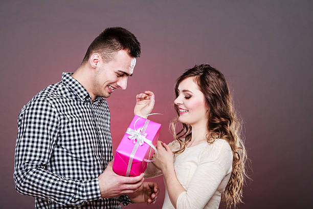 istock happy romantic couple with gift 627476098