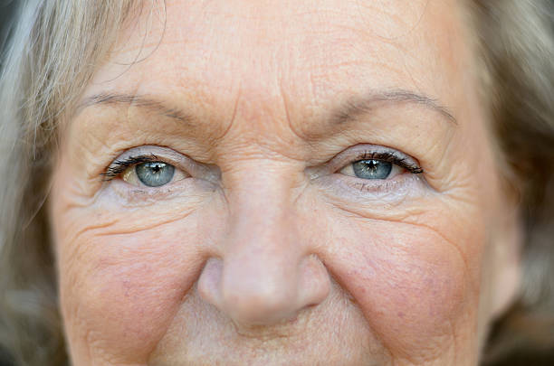 istock Attractive senior woman with blue eyes 627478118