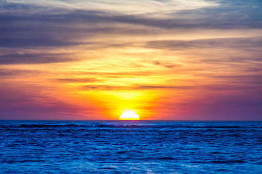 sunset above the sea. Golden and red sea and purple sky. Beautiful seascape. Composition of nature. select focus