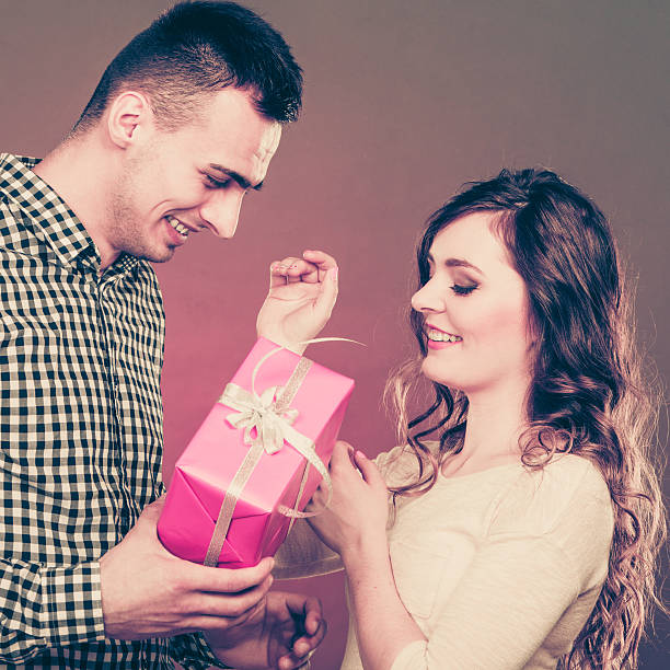 istock happy romantic couple with gift 627489448
