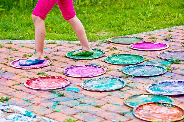 Photo of feet of children full of colorful gouache