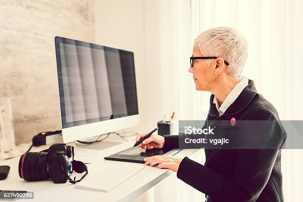 Mature Businesswoman Working In Her Home Office Stock Photo - Download Image Now - Organization, Photographer, Photography