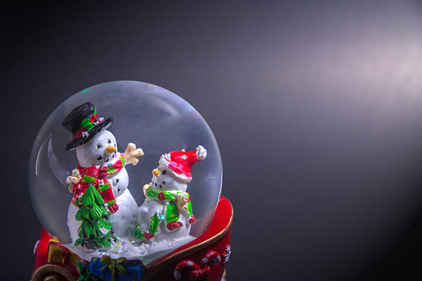 istock Christmas snow globe with snowman isolated on black background 627490518
