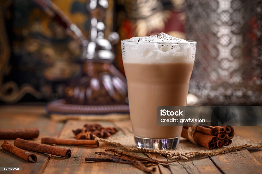 Delicious chai latte Large glass of delicious chai latte with a sprinkle of cinnamon Chai Stock Photo