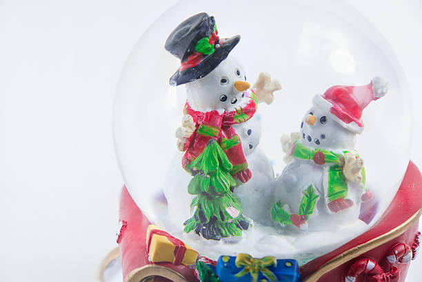istock Close-up Christmas snow globe with snowman isolated on white background 627491176