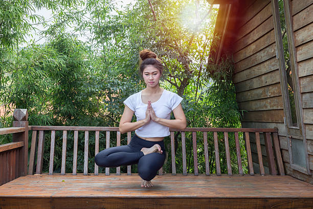 istock women relaxing in yoga toe stand pose 627491288