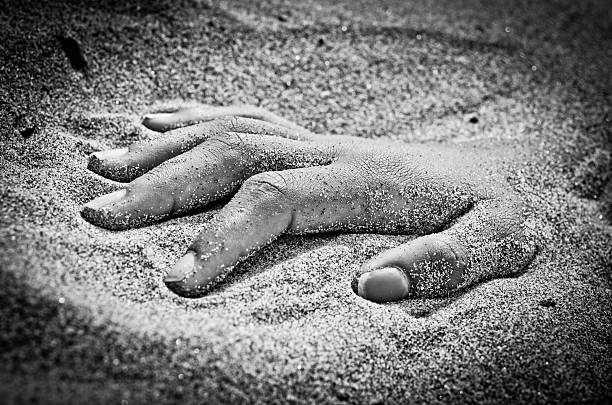 istock hand in rigor mortis on the beach 627491290
