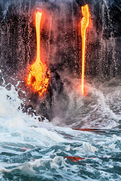 Molten lava flowing into the Pacific Ocean on Big Island Molten lava flowing into the Pacific Ocean on Big Island forming a teardrop shape pele stock pictures, royalty-free photos & images
