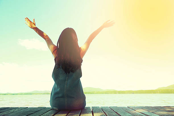 istock woman sit alone at the edge of  bridge 627499594