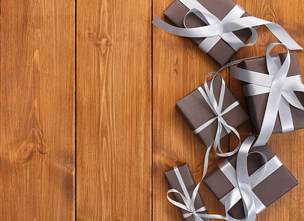 istock Presents in gift boxes on wood background with copy space 627500144