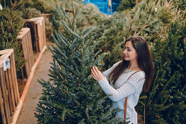 istock girl and Christmas tree 627500694
