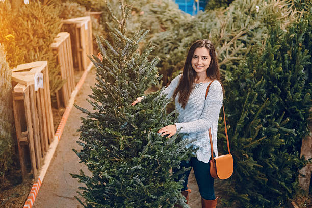 istock girl and Christmas tree 627500748