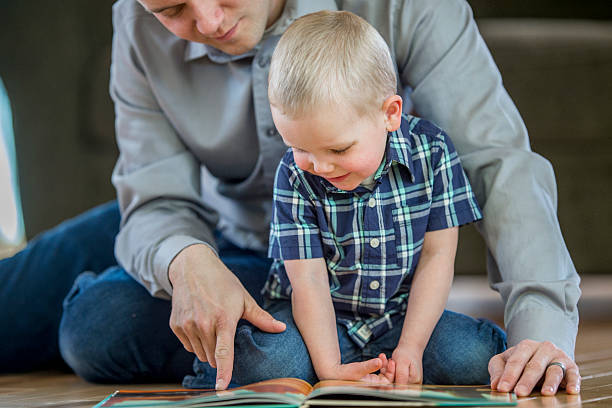 istock Looking at a New Book Together 627503056