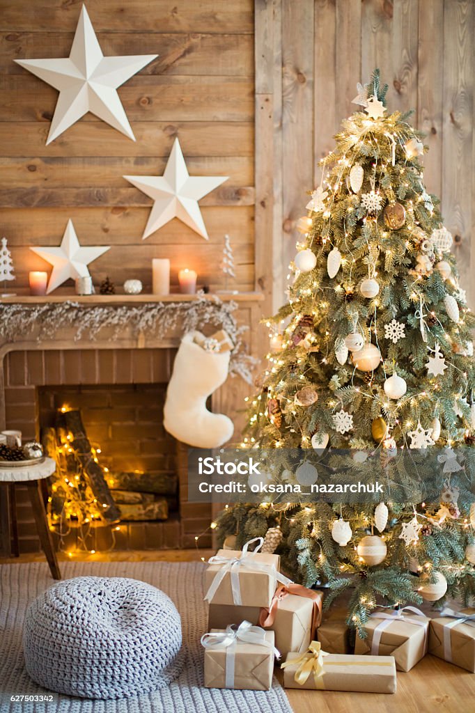 winter decor Christmas tree with vintage decorations near fireplace Christmas Stock Photo