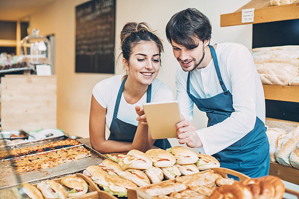 Couple of bakers with digital tablet