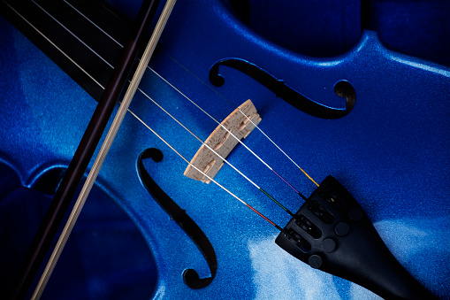 Detail of a violin with blue glitter varnish, music instrument background, selected focus