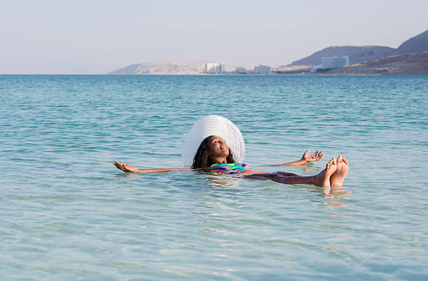istock Woman floating in Dead Sea. 627522888
