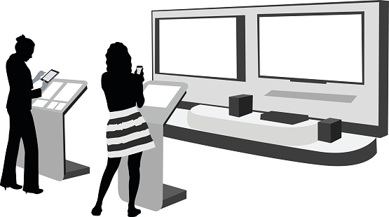 A vector silhouette illustration of two young women browsing handheld electronic devices at an electronics store.  They standing infront of display podiums with a large smart tv display in front of them.
