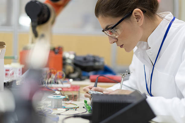 istock Female engineer working on circuit board at desk 627523852