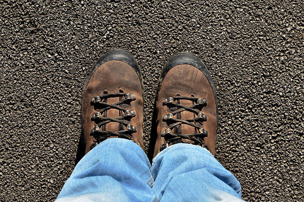 istock Mountain boots on the street in sunny day 627524210