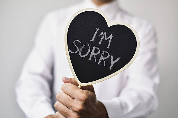 istock man with a signboard with the text I am sorry 627541078