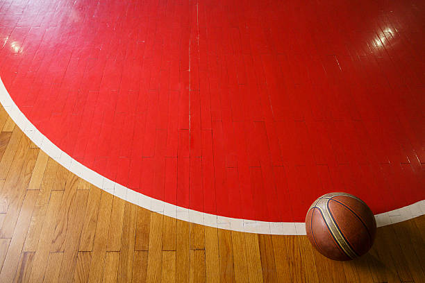 istock Basketball ball on court floor 627541950
