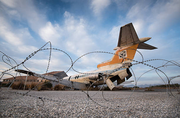 The famous US Navy DC-3 aircraft wreck resting on the black volcanic sands of Sólheimasandur, Iceland with Black sand rock on the foreground. Shot on iPhone.