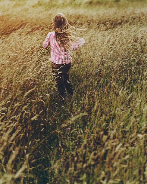 istock Little Girl Grassland Nature Outdoors Concept 627543392