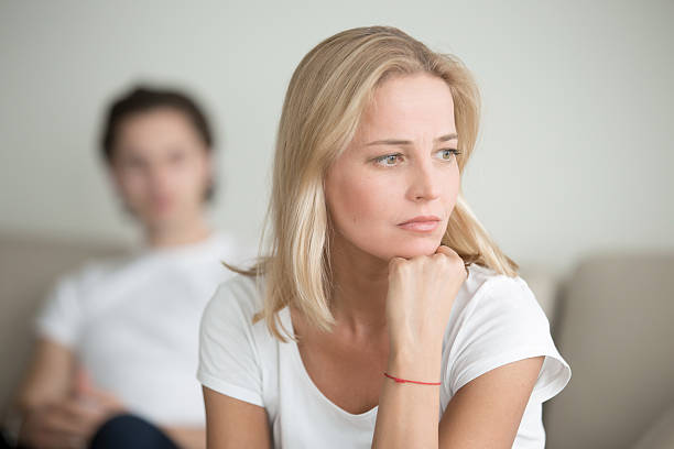 istock Serious sad woman thinking over a problem, man sitting aside 627543522