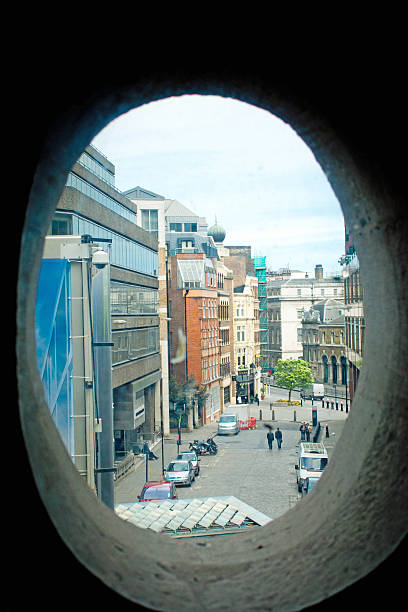 London, UK - May 4, 2015: London backstreet near The Monument with a view through office buildings towards West London.