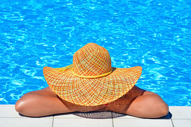 istock Real female beauty relaxing at swimming pool 627558546