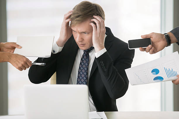 istock Young businessman grabbing his head 627559442