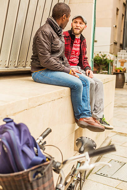 istock Romantic Gay Hipster Couple Sitting Together Talking 627574332