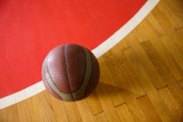 istock Basketball ball on court floor 627574474