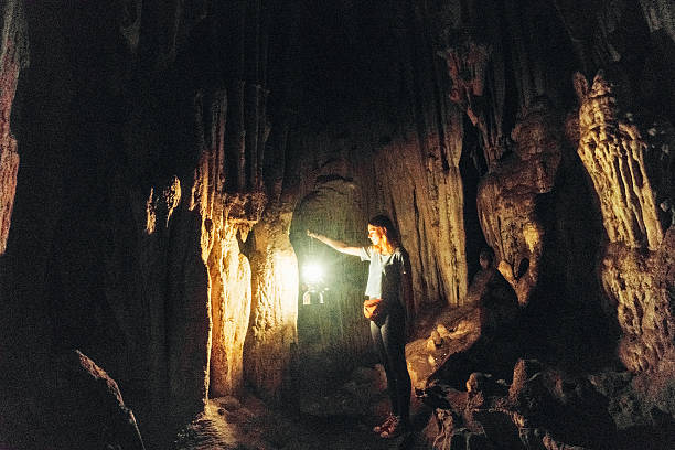 istock Woman with lantern in the cave 627581710